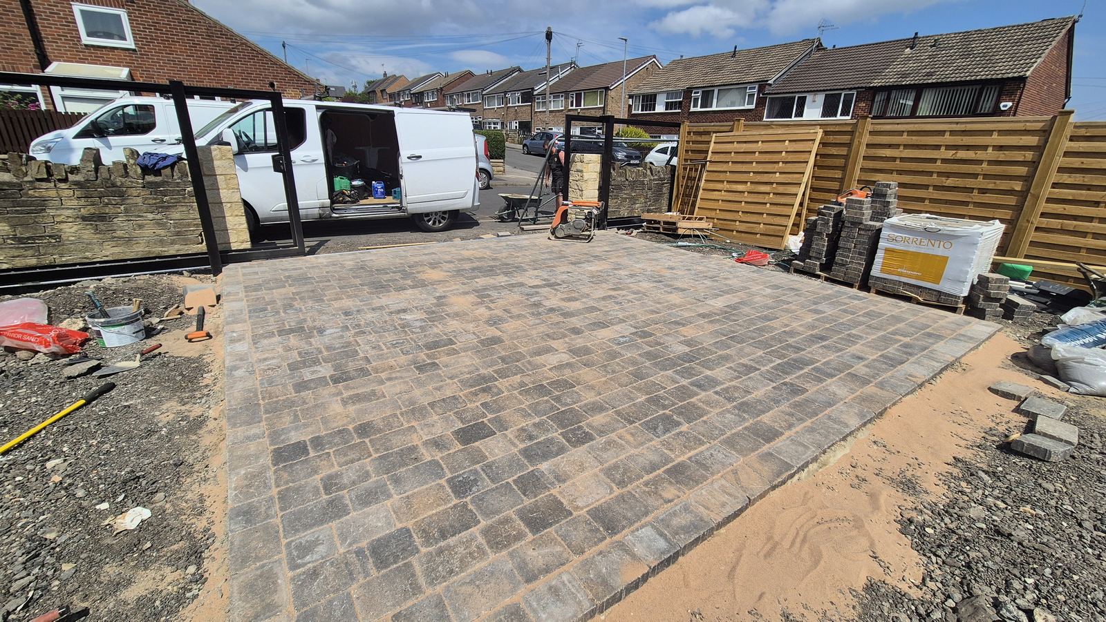 a driveway going down mid-lay, compactor on