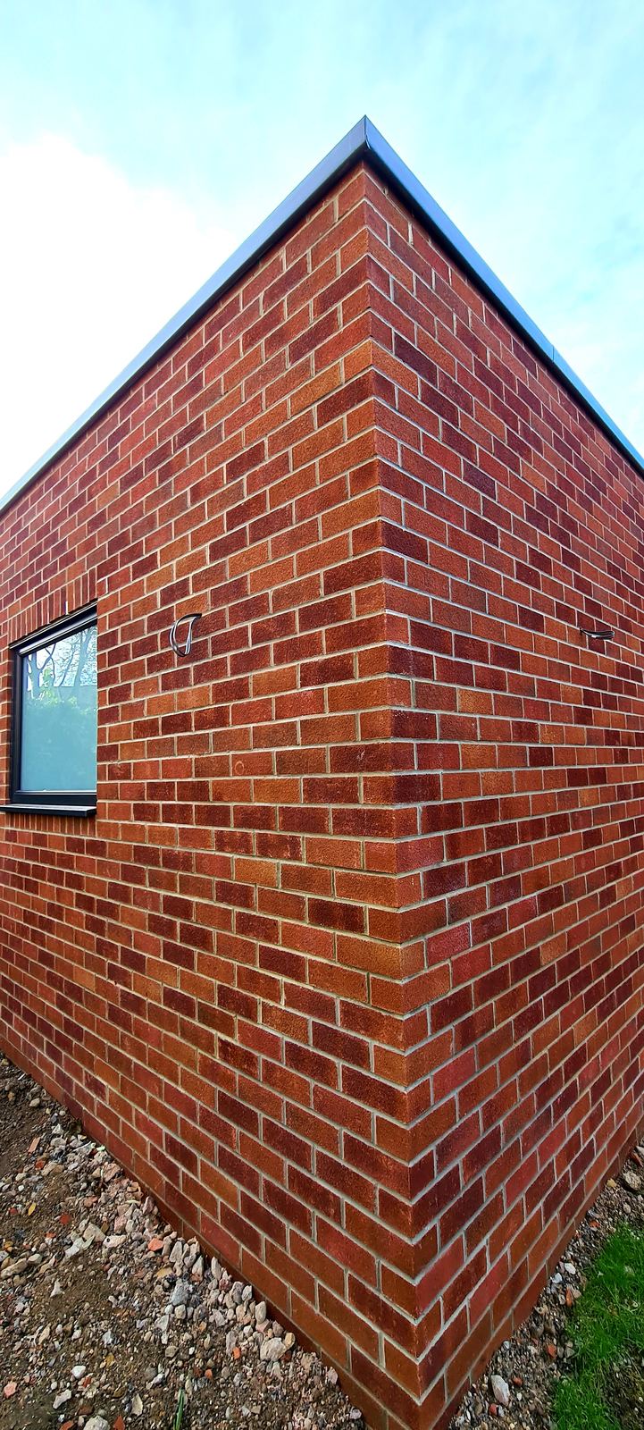 brick extension corner, courses running true up to the roof trim