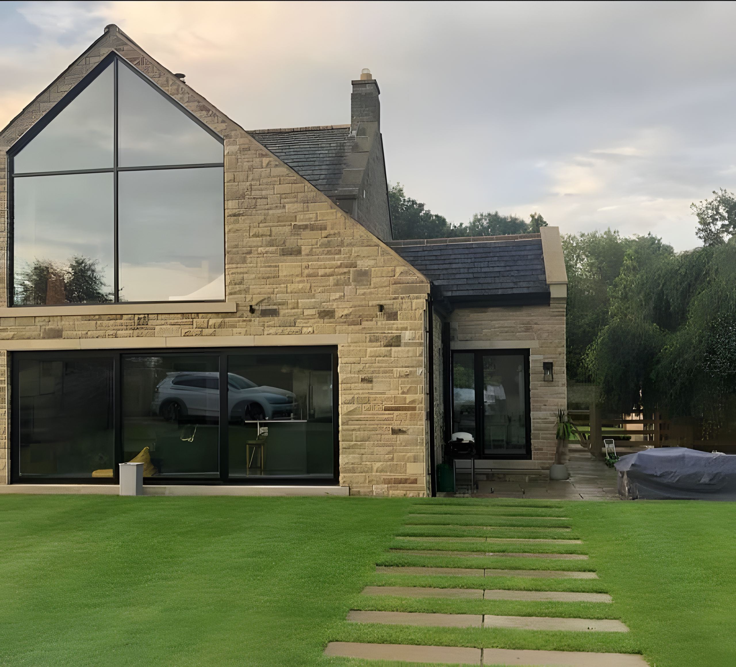 wide dusk shot, finished patio and lit extension