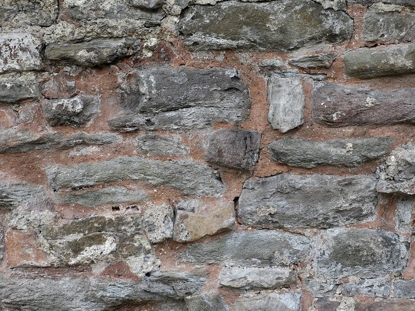 random rubble wall, uncoursed stone of mixed sizes bedded in mortar