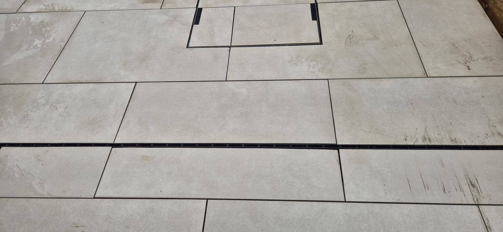 close-up. Consistent joints across the bay, the channel drain let in flush