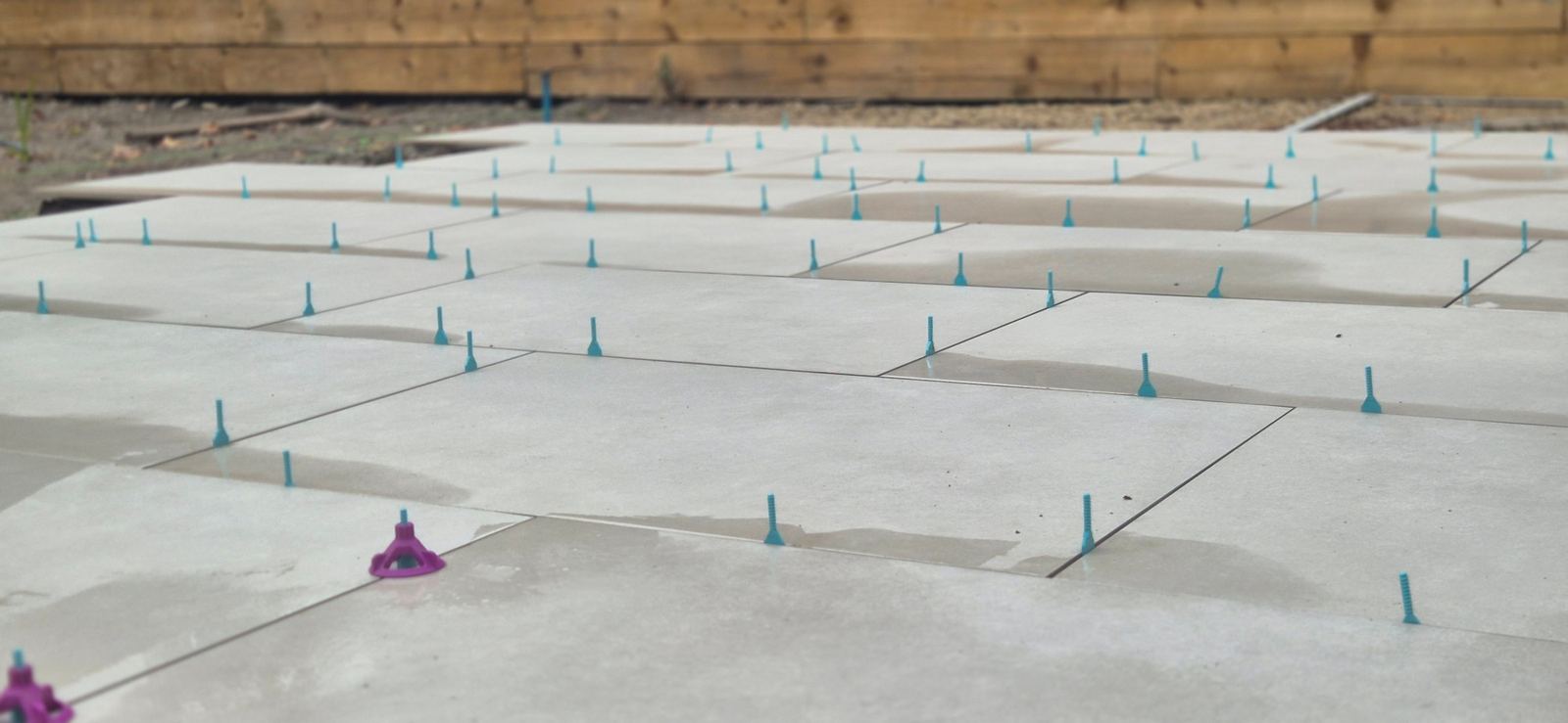 large-format porcelain going down on the levelling clips, joints gauged tight