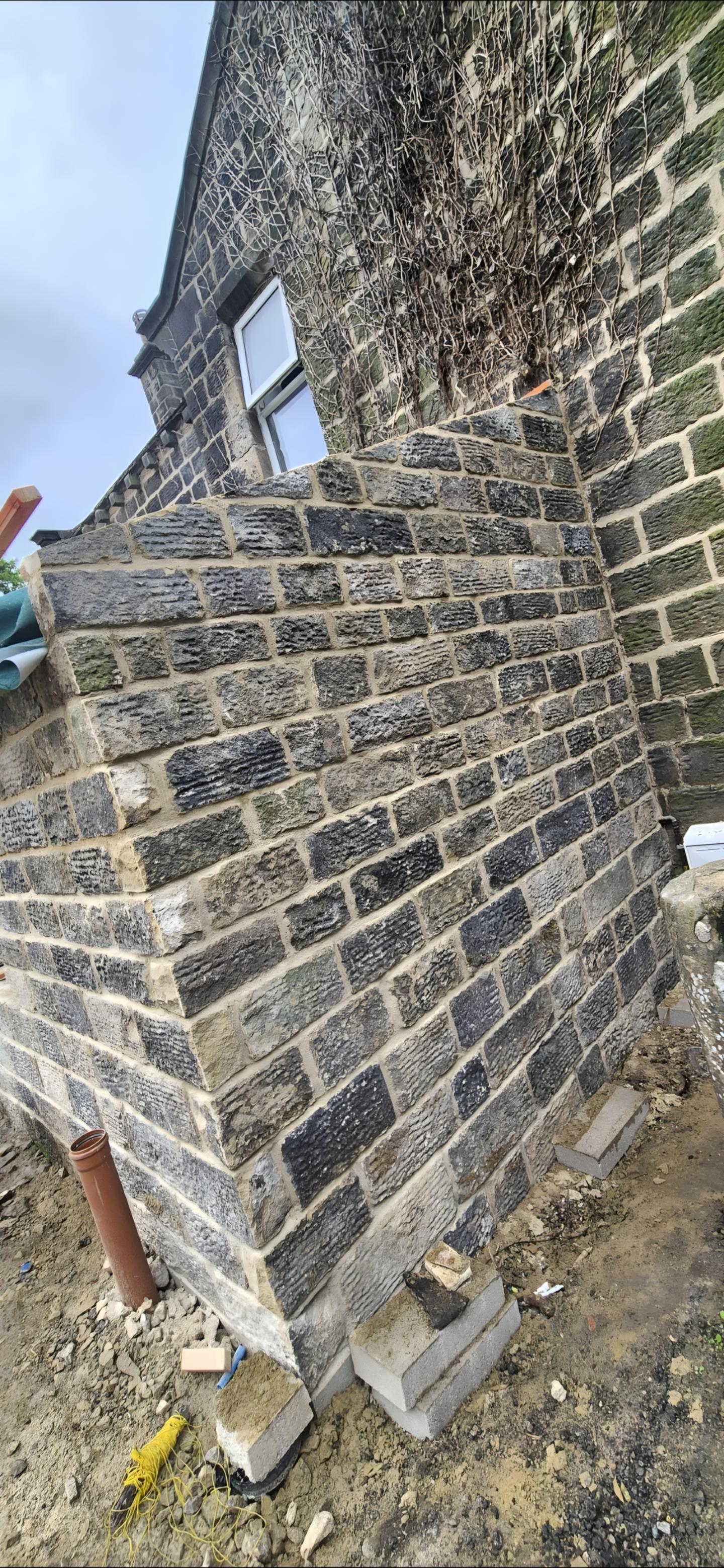 New reclaimed coursing meeting the original wall, the joint barely visible