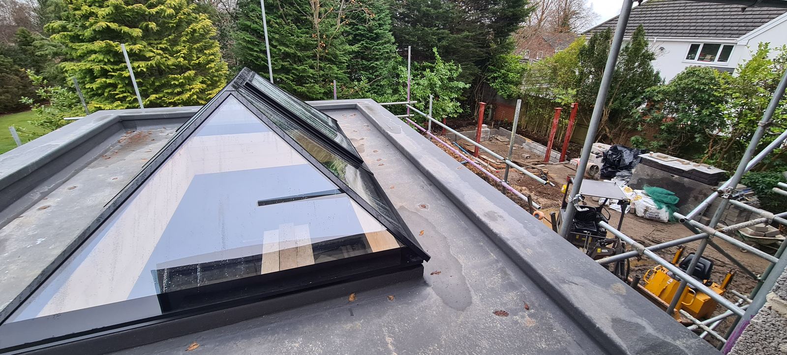 a new glass roof lantern on the flat roof, props still under the blockwork