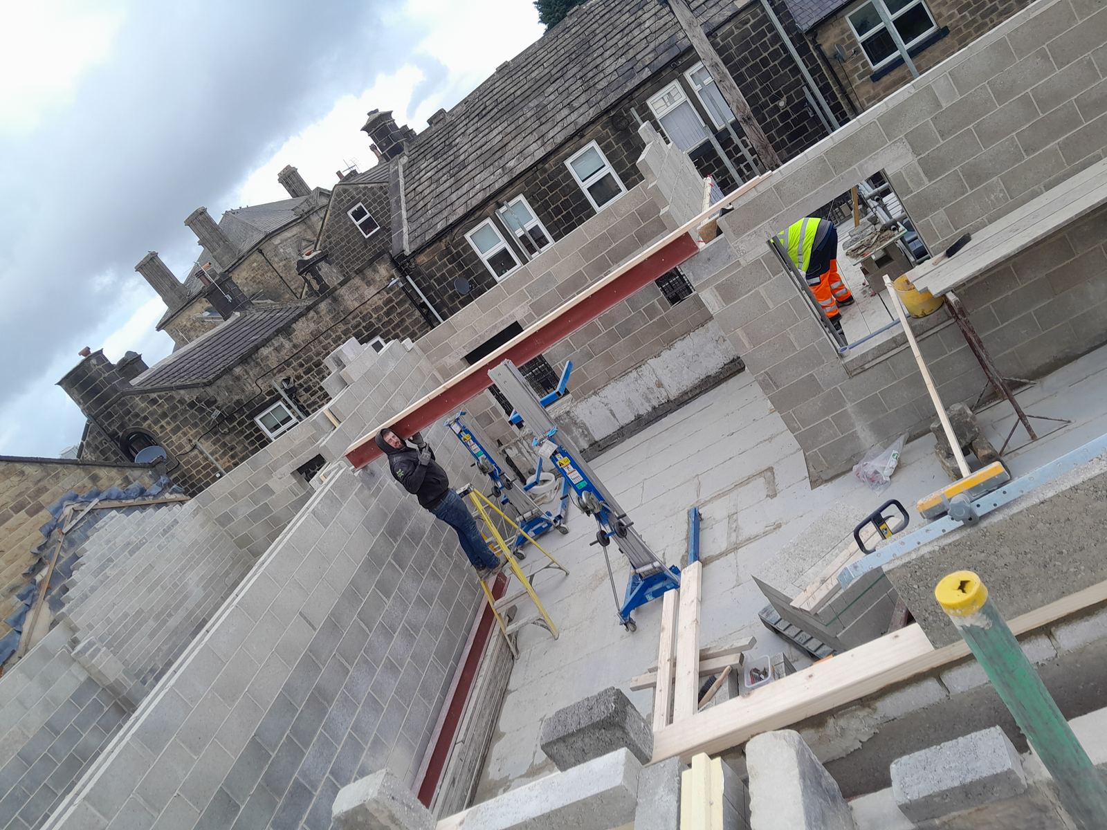 a steel braced on a stone wall, mid-build