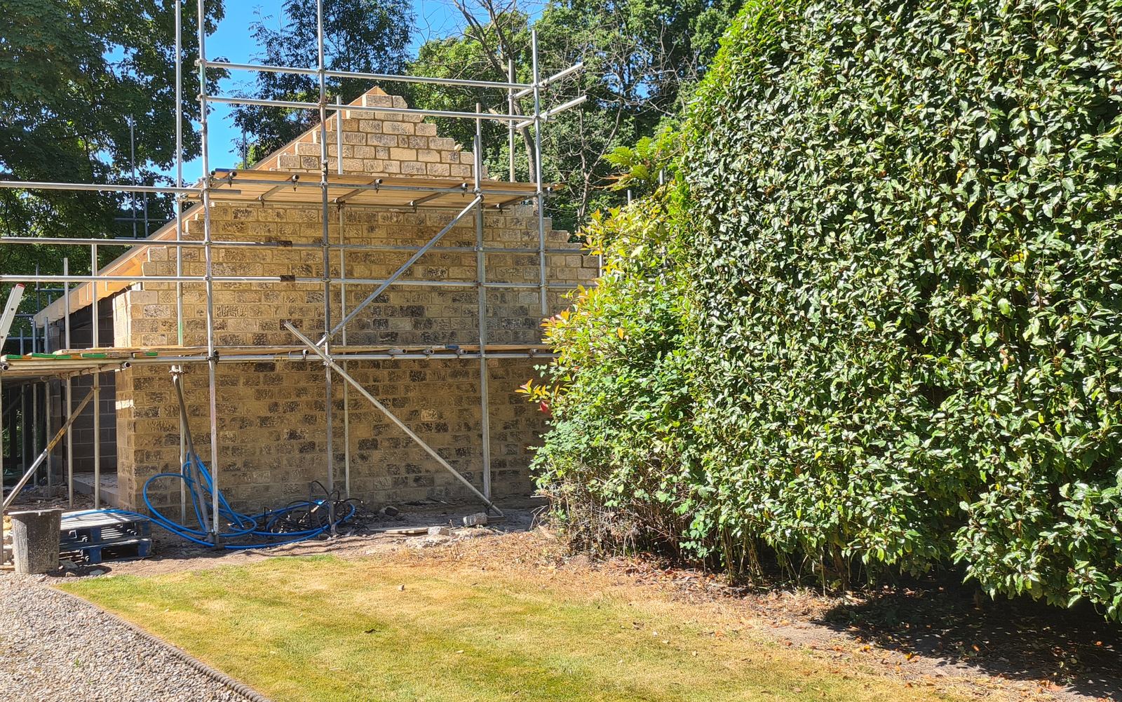 a stone gable coursed up under scaffold on one of our builds