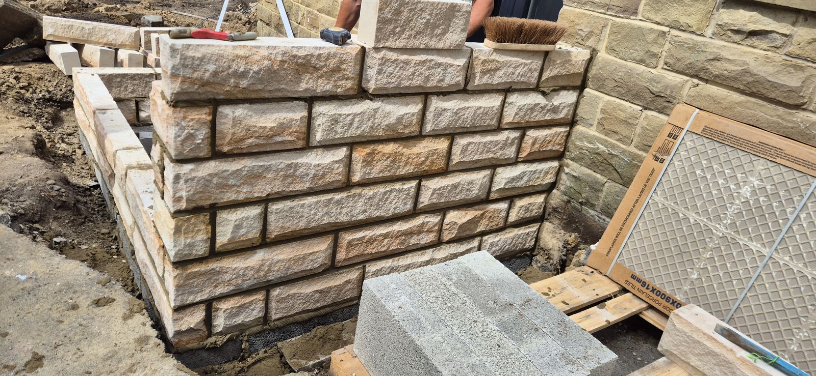 the porch dwarf walls coursed and pointed in dressed stone, close