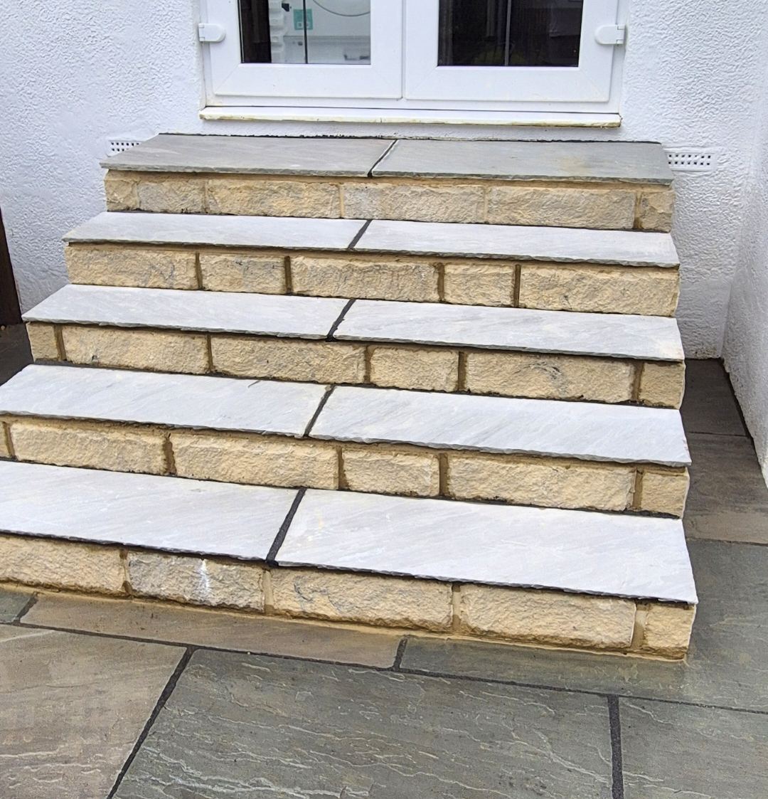 stone steps up to the back door, risers coursed in stone