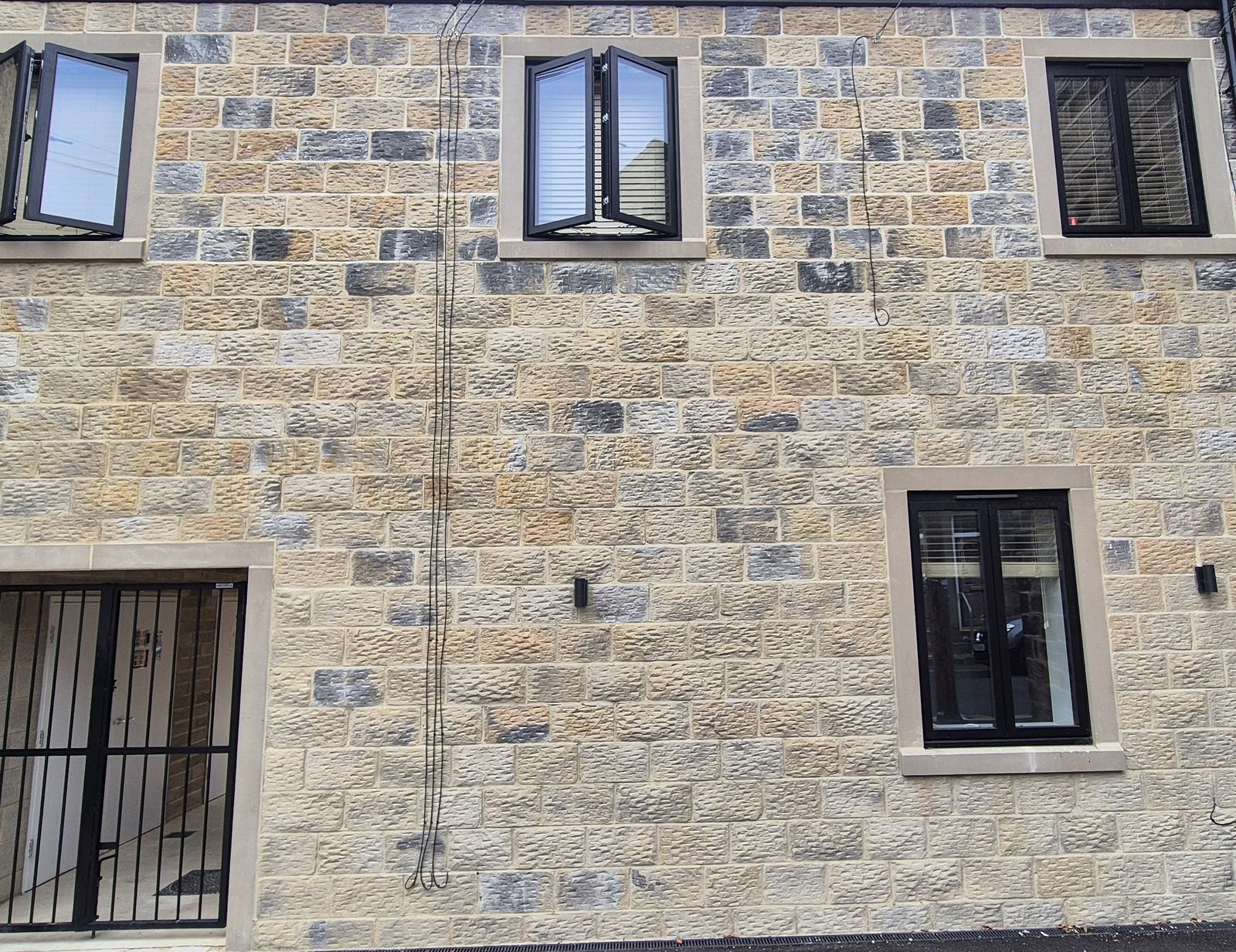 two-storey coursed stone elevation in Horsforth, dressed stone window surrounds
