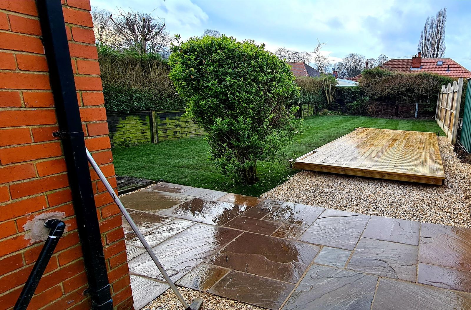 timber deck across the garden from the patio, lawn between