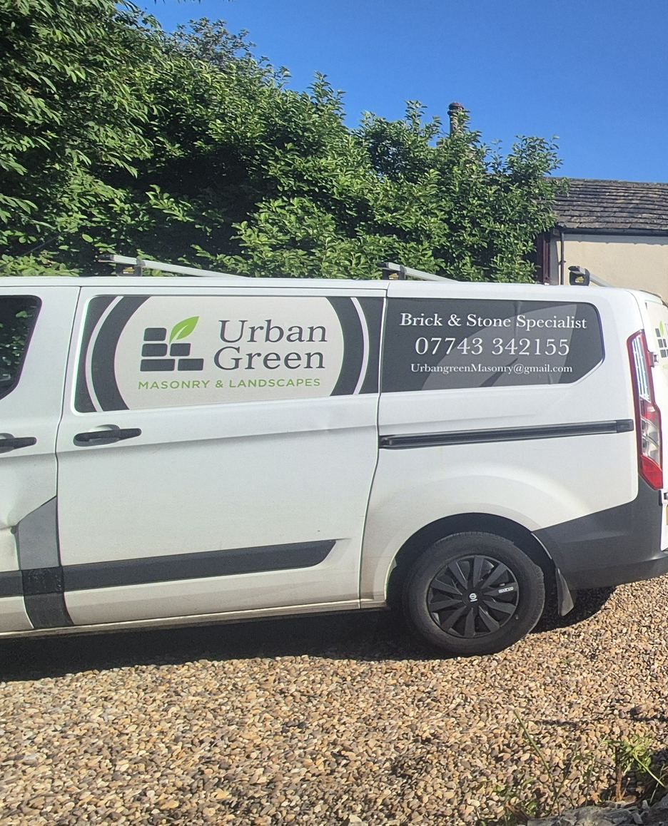 The Urban Green van parked on the gravel drive at a stone farmhouse job